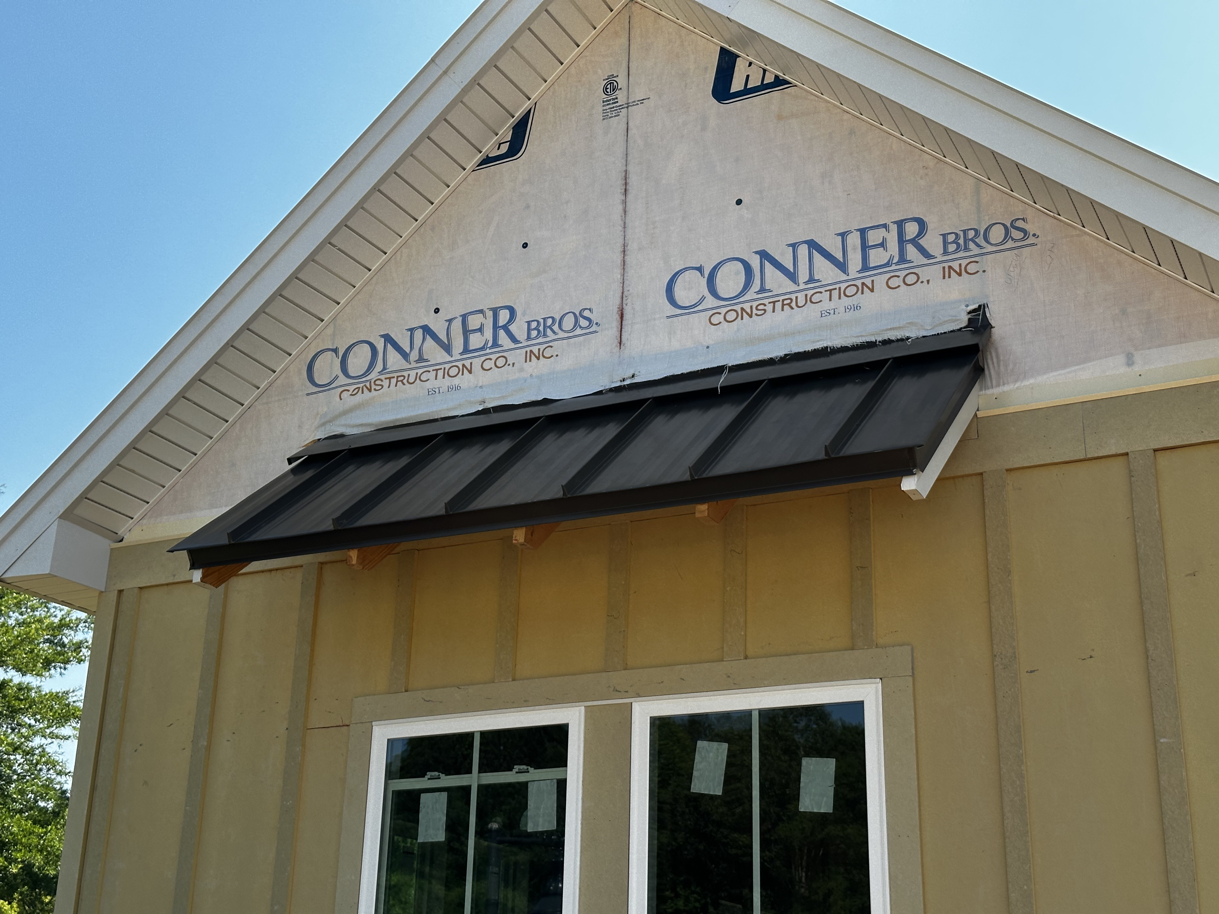 Metal shed roof with wall apron flashing and wrapped rakes conner brothers construction auburn al