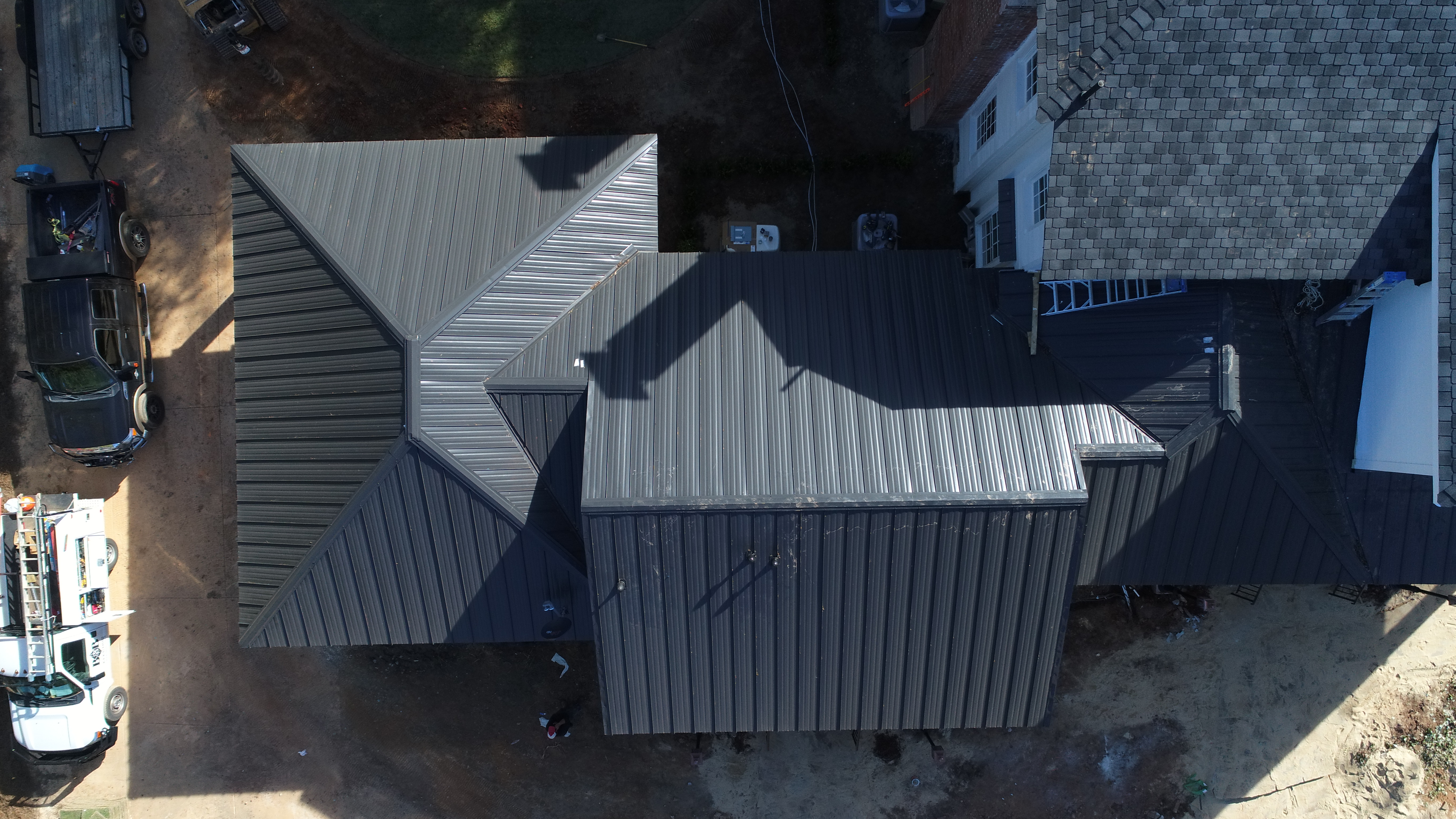 High-angle drone shot of metal to shingle transition