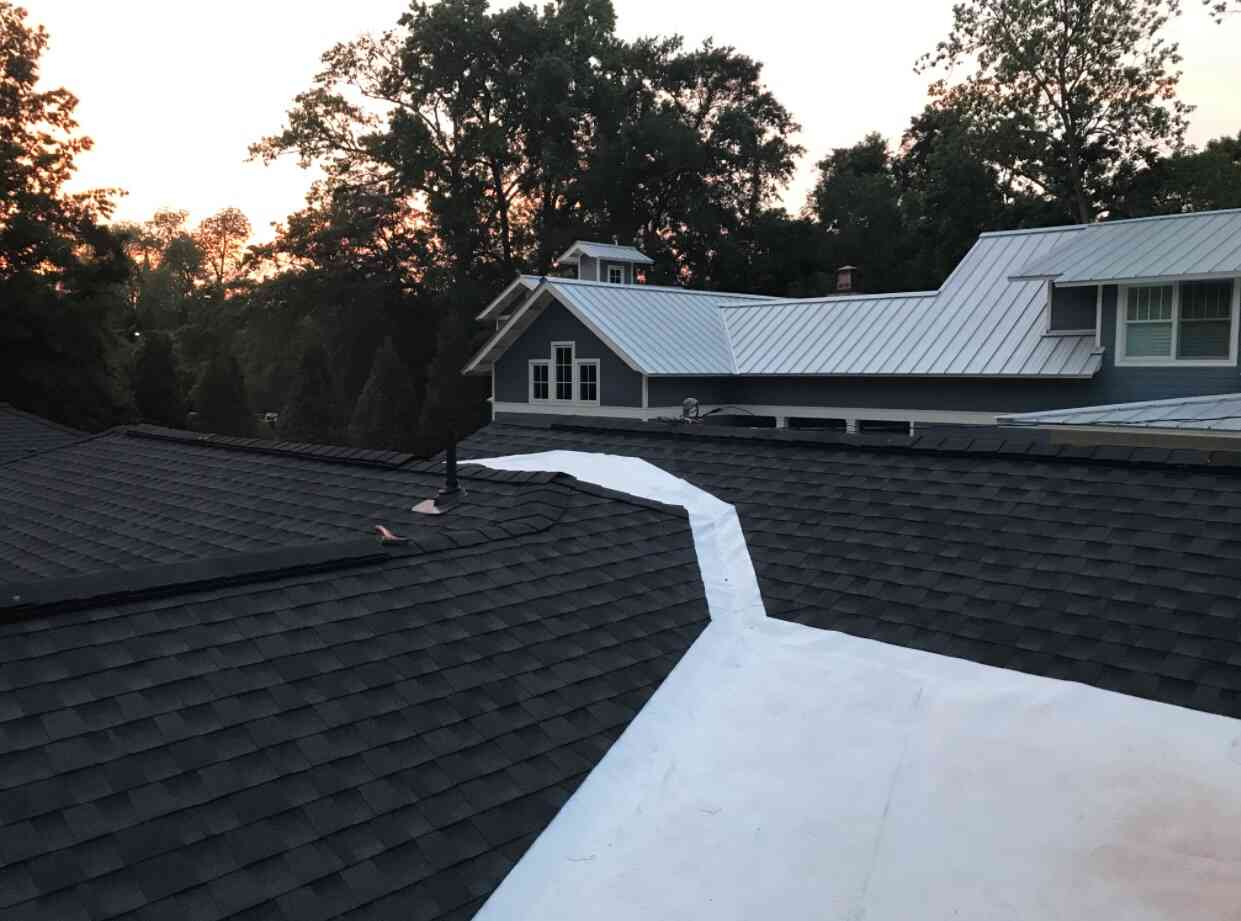 Architectural shingles with low-slope tie-in
